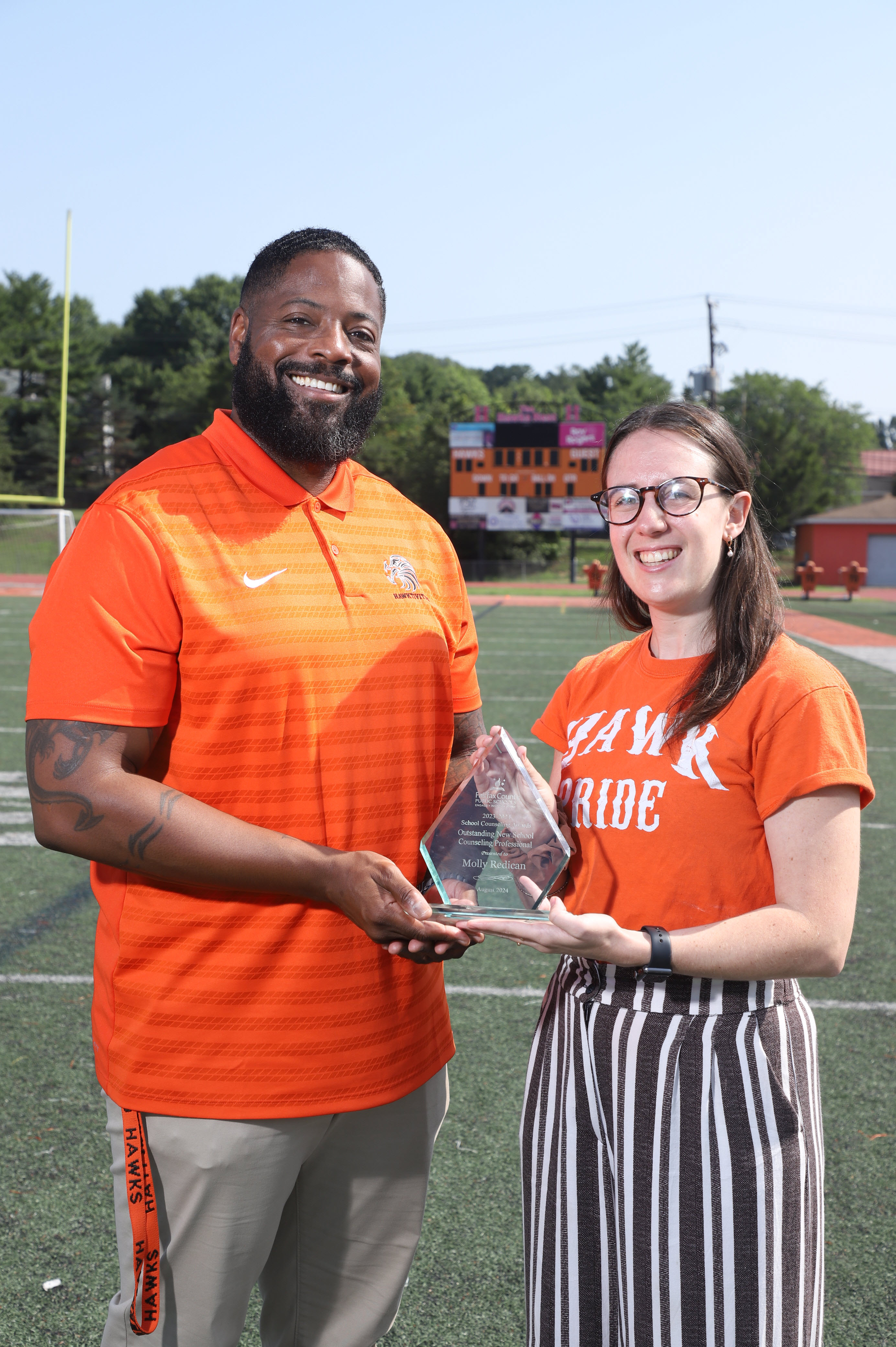 Dr. Thompson and Molly Redican smile with Molly's outstanding award.