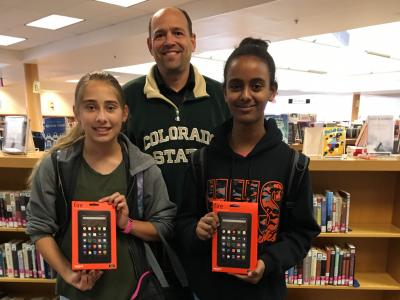 Students pose with Mr. Grimm and their new Kindles