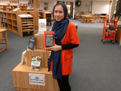 student poses with her new Kindle